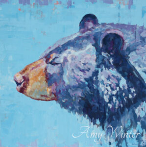 black bear portrait against a blue background
